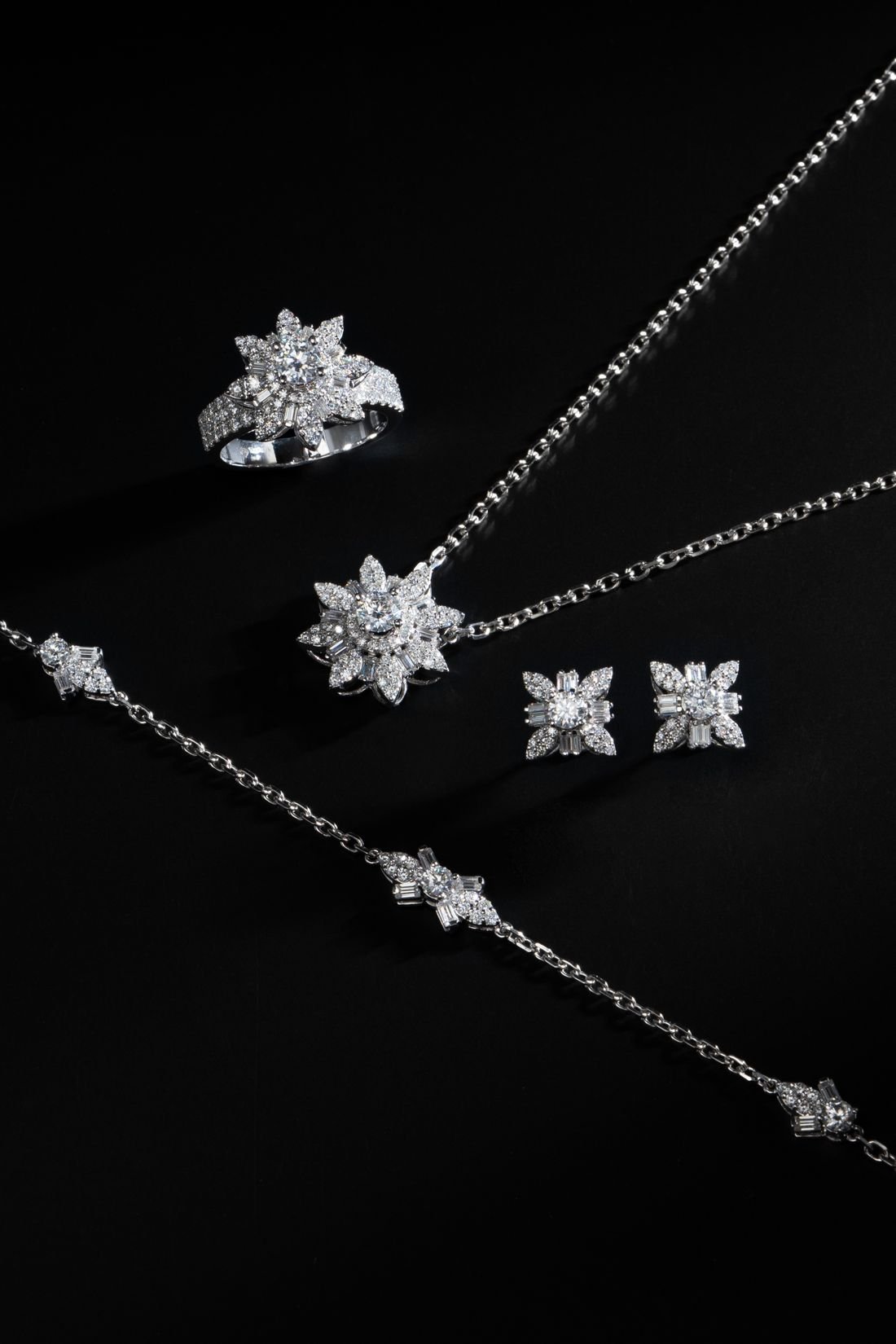 A matching set of lab-grown diamond ring, necklace, earrings and bracelet